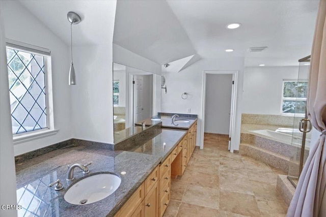 full bath featuring a wealth of natural light, lofted ceiling, and a sink