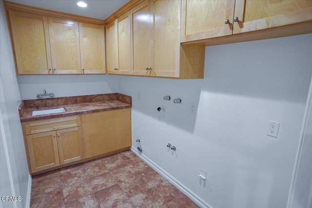 laundry room featuring a sink, hookup for a gas dryer, baseboards, recessed lighting, and cabinet space