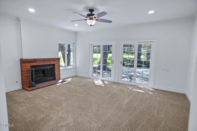 unfurnished living room with baseboards, ceiling fan, crown molding, and carpet flooring