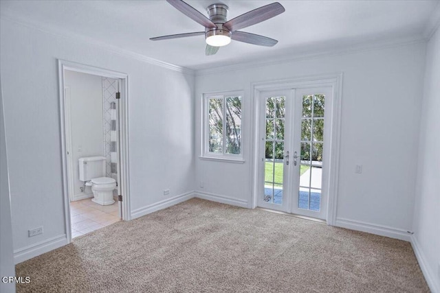 unfurnished bedroom featuring crown molding, baseboards, carpet floors, french doors, and access to outside