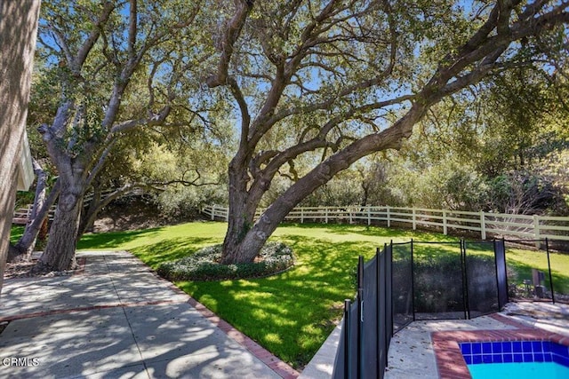 view of yard with fence and a patio