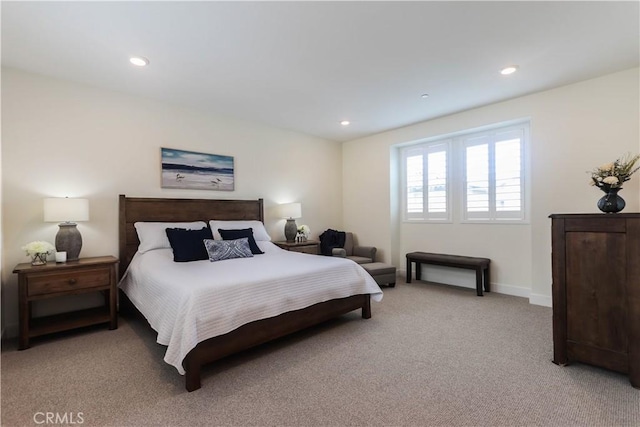 bedroom with baseboards, recessed lighting, and light carpet