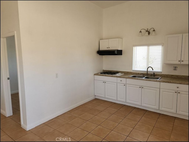 8581 Montara Rd, Pinon Hills, CA 92372 - kitchen with white cabinetry, light tile patterned floors, white gas cooktop, and a sink