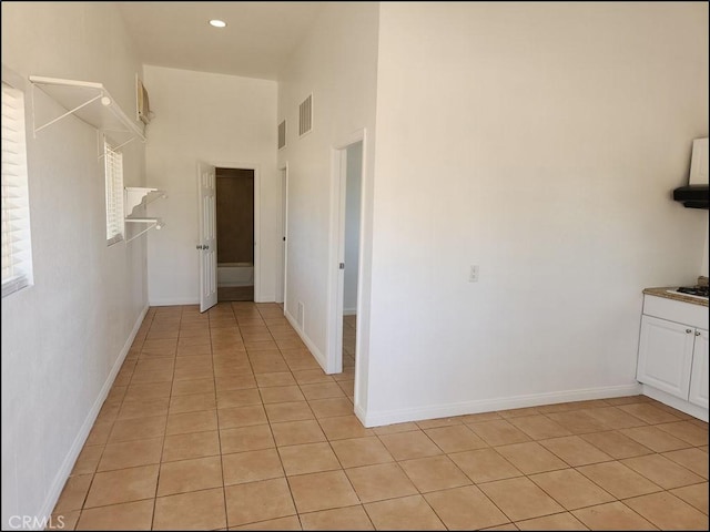 8581 Montara Rd, Pinon Hills, CA 92372 - hallway with baseboards, visible vents, light tile patterned floors, and a towering ceiling