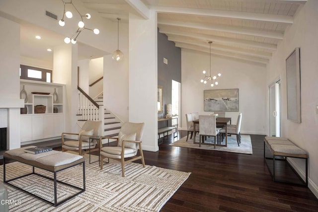 living area with visible vents, a chandelier, hardwood / wood-style floors, beam ceiling, and high vaulted ceiling