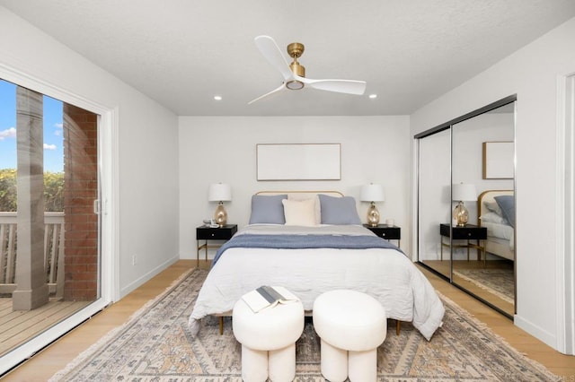 bedroom with ceiling fan, recessed lighting, light wood-style flooring, and a closet