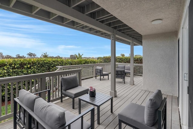 wooden deck with an outdoor living space