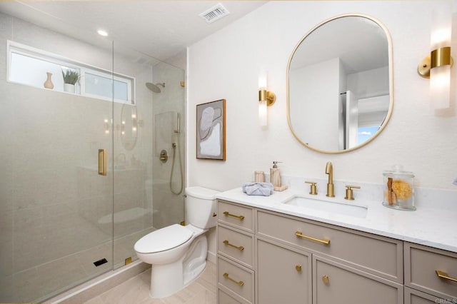 full bathroom featuring visible vents, a stall shower, toilet, and vanity