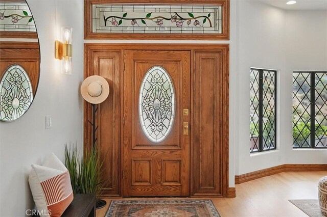 foyer entrance with light wood-type flooring and baseboards