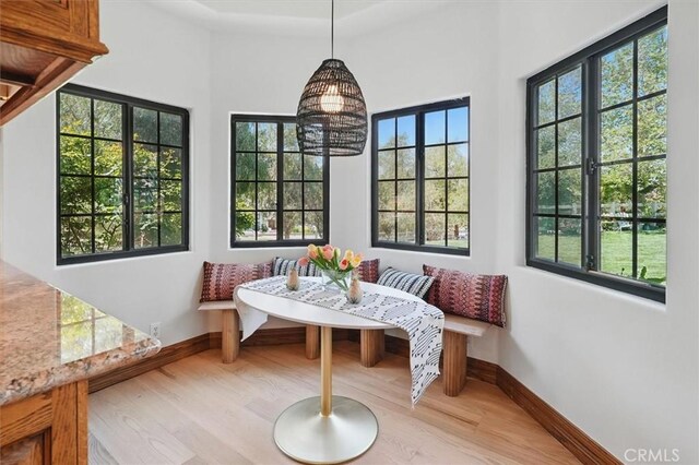 sunroom / solarium with a chandelier