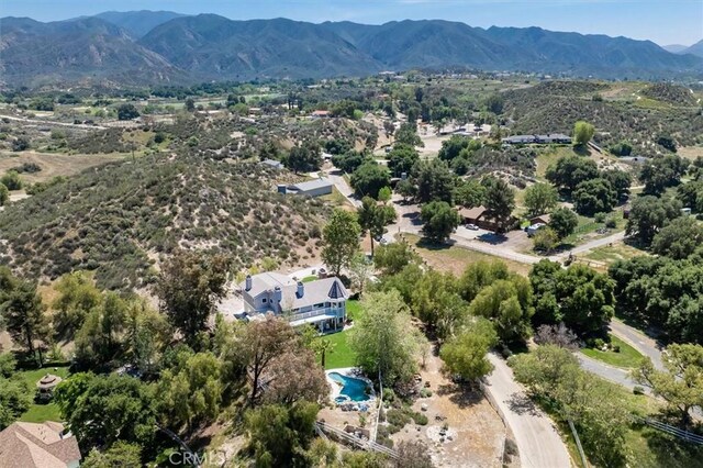 birds eye view of property featuring a mountain view