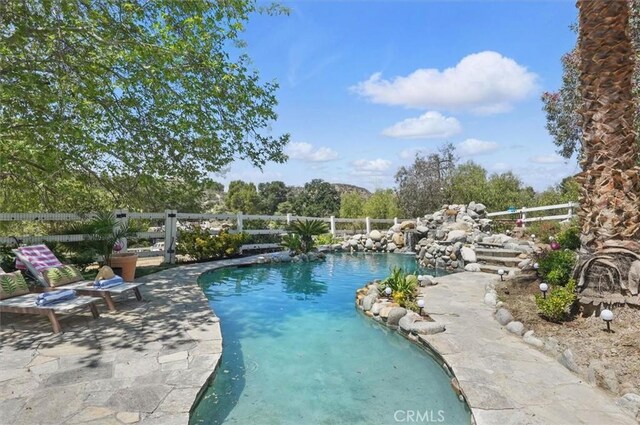 view of pool featuring a patio, fence, and a fenced in pool