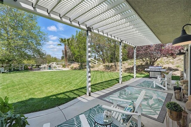 view of patio with area for grilling and a pergola