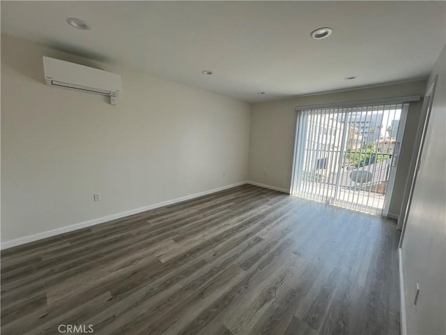 1548 N Alexandria Ave, Los Angeles, CA 90027 - unfurnished room with a wall unit AC, dark wood-type flooring, baseboards, and recessed lighting