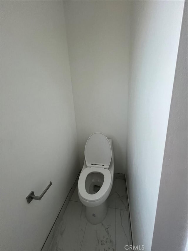 1548 N Alexandria Ave, Los Angeles, CA 90027 - bathroom featuring toilet and marble look tile flooring