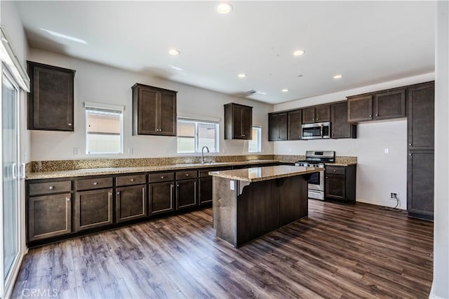 217 Oberlander Way, Fallbrook, CA 92028 - kitchen with stainless steel appliances, dark brown cabinetry, dark wood-style floors, a center island, and recessed lighting