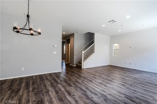 unfurnished living room featuring recessed lighting, stairs, dark wood-style floors, visible vents, and a notable chandelier
