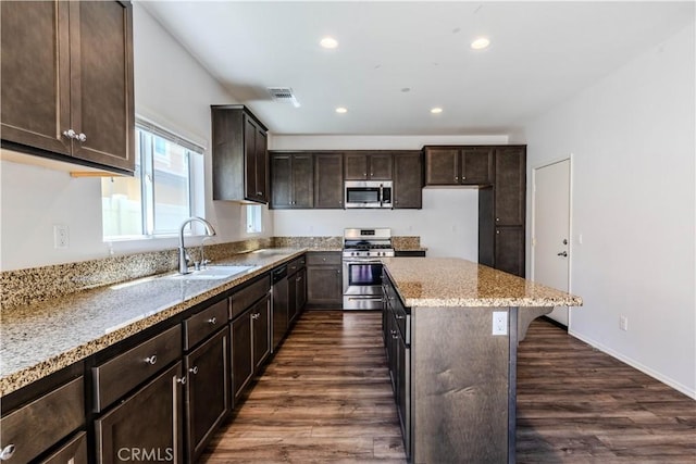 217 Oberlander Way, Fallbrook, CA 92028 - kitchen featuring a sink, appliances with stainless steel finishes, a kitchen island, dark brown cabinets, and light stone counters