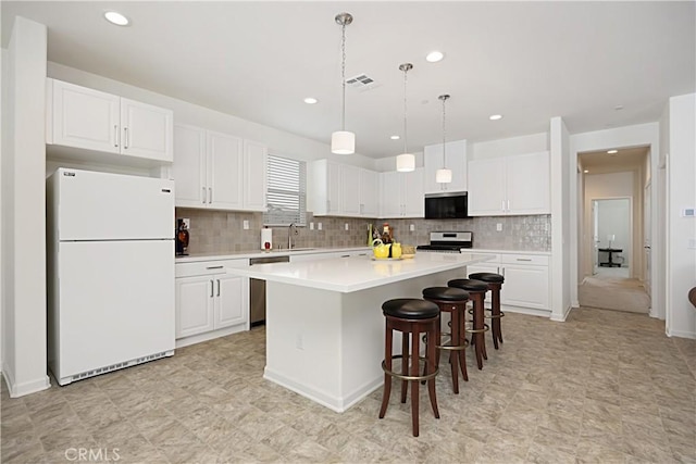 36225 Beacon Light Way, Wildomar, CA 92595 - kitchen with stainless steel appliances, white cabinets, light countertops, decorative backsplash, and recessed lighting