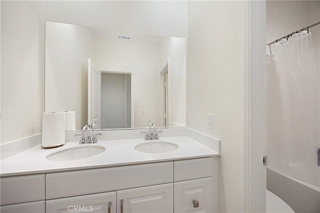 36225 Beacon Light Way, Wildomar, CA 92595 - bathroom featuring double vanity, visible vents, shower / bath combo, and a sink