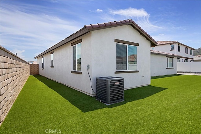 36225 Beacon Light Way, Wildomar, CA 92595 - rear view of property with a yard, central air condition unit, stucco siding, and a fenced backyard