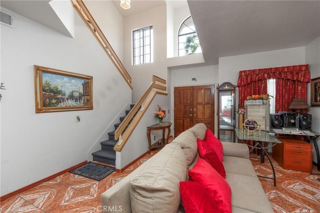 22527 Mountain View Rd, Moreno Valley, CA 92557 - living area featuring stairway, a high ceiling, and visible vents