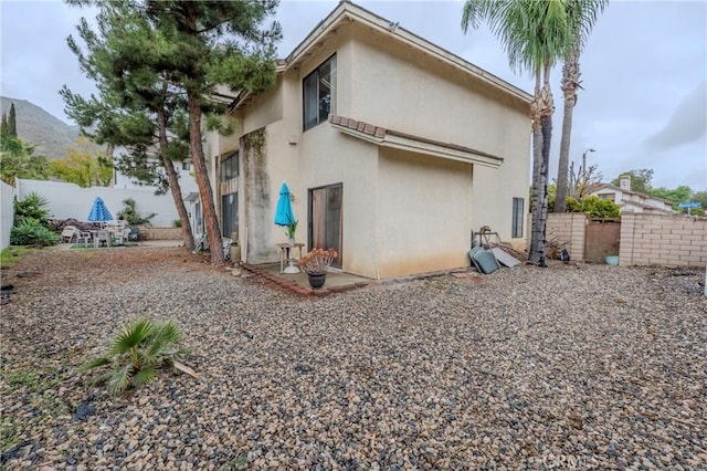 22527 Mountain View Rd, Moreno Valley, CA 92557 - rear view of property with stucco siding and fence