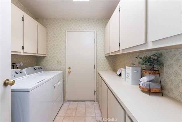 laundry room with wallpapered walls, cabinet space, light tile patterned flooring, and independent washer and dryer
