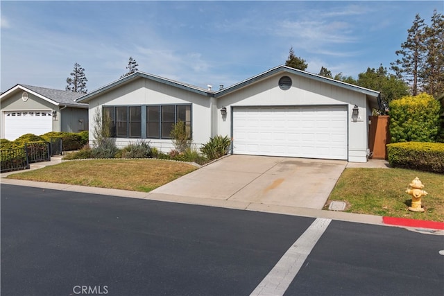 ranch-style home with fence, a front lawn, and an attached garage