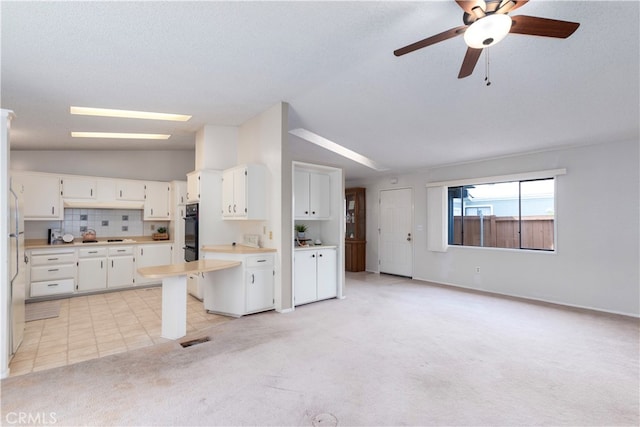 unfurnished living room with light colored carpet, visible vents, ceiling fan, and lofted ceiling