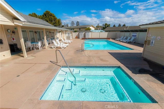 pool featuring fence and a patio