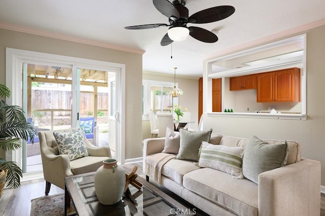 17355 Ridgedale Ln, Yorba Linda, CA 92886 - living room featuring baseboards, ornamental molding, ceiling fan with notable chandelier, and wood finished floors