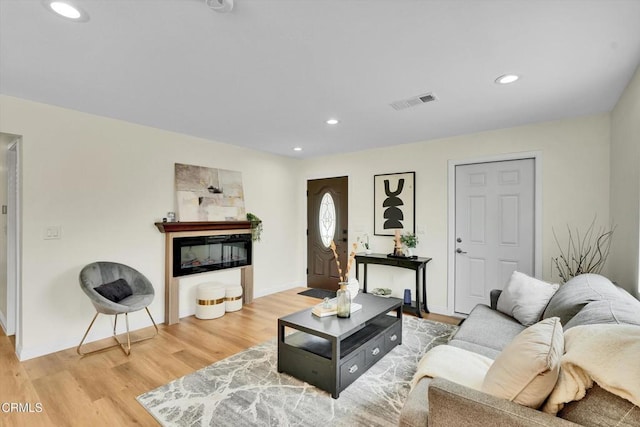 17632 E Covina Blvd, Covina, CA 91722 - living room featuring light wood-type flooring, recessed lighting, and a glass covered fireplace