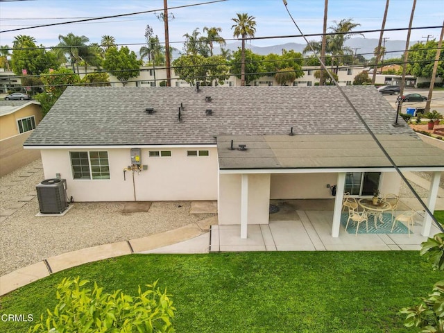 17632 E Covina Blvd, Covina, CA 91722 - rear view of property featuring a shingled roof, a patio area, stucco siding, a yard, and a mountain view