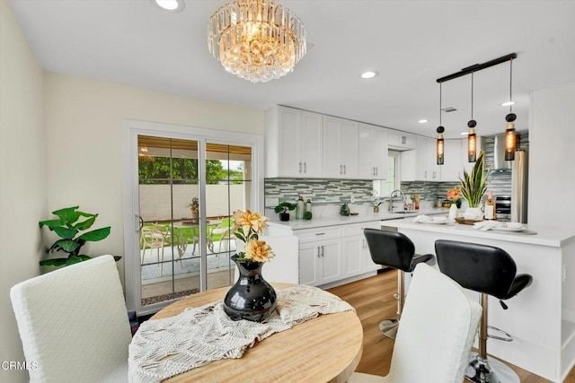 17632 E Covina Blvd, Covina, CA 91722 - kitchen featuring light countertops, tasteful backsplash, white cabinetry, light wood-style floors, and recessed lighting
