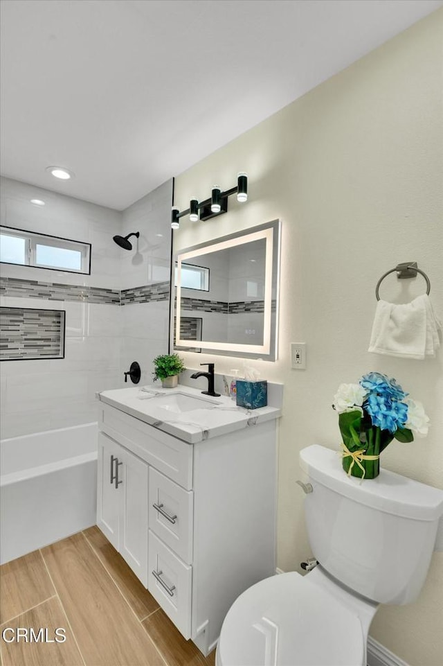 17632 E Covina Blvd, Covina, CA 91722 - bathroom with vanity, washtub / shower combination, and wood finished floors