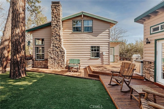 879 Orange Ave, Sugarloaf, CA 92386 - back of house with a deck, a chimney, a yard, and stone siding