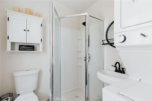 879 Orange Ave, Sugarloaf, CA 92386 - bathroom featuring toilet, stacked washer and clothes dryer, a shower stall, and a sink