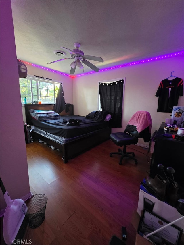 bedroom with a ceiling fan and wood finished floors