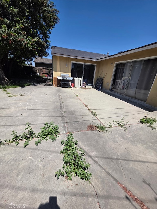 exterior space featuring stucco siding and a patio area