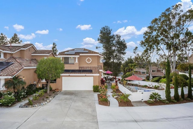 1512 Golfcrest Pl, Vista, CA 92081 - view of front facade with concrete driveway, stucco siding, solar panels, an attached garage, and a gate