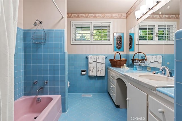 1273 E 7th St, Chico, CA 95928 - bathroom featuring tile walls, tile patterned floors, shower / bath combo, vanity, and wainscoting