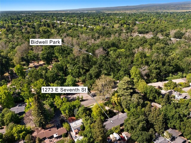 1273 E 7th St, Chico, CA 95928 - aerial view of property and surrounding area featuring a heavily wooded area