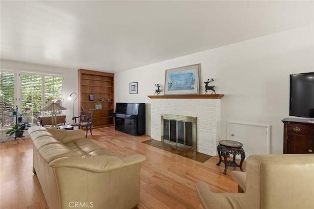 1273 E 7th St, Chico, CA 95928 - living area with a brick fireplace and wood finished floors