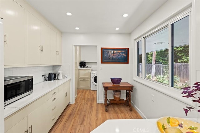 1273 E 7th St, Chico, CA 95928 - kitchen with stainless steel microwave, washer / dryer, light wood-style floors, recessed lighting, and light countertops