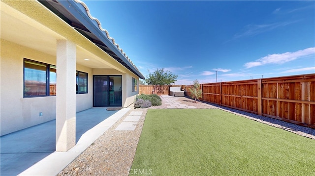 view of yard featuring a patio and a fenced backyard