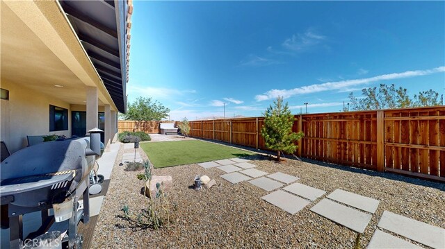 view of yard with a fenced backyard and a patio area