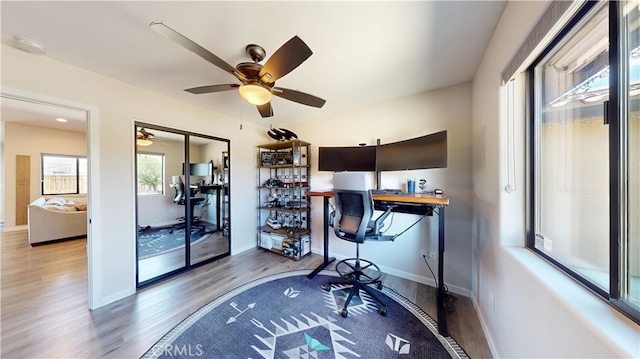 office area featuring baseboards, wood finished floors, and ceiling fan