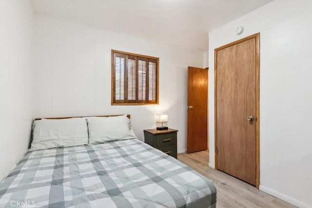 bedroom with baseboards and light wood-type flooring