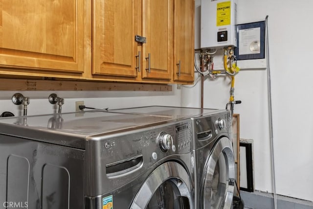 clothes washing area with tankless water heater and washer and clothes dryer